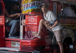 A barker at the rear of his jeepney, Marikina